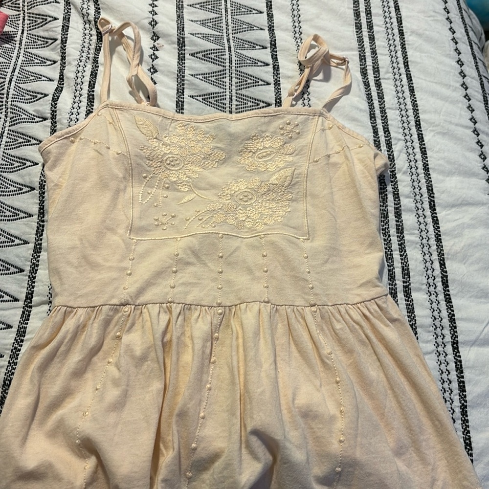 Light yellow tank with floral pattern